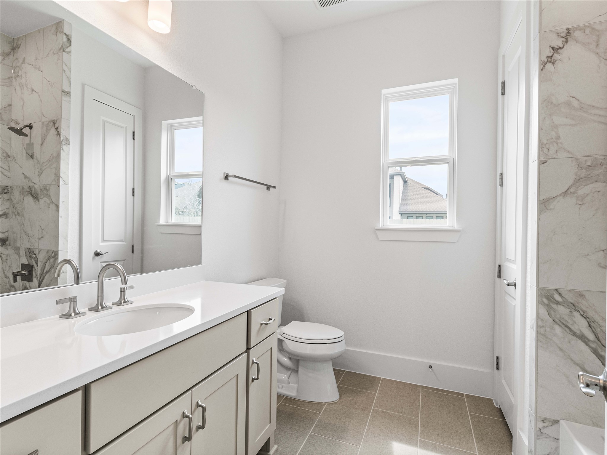 4926 Grapevine Lane Manvel, TX 77578 - Photo 16 of 41 a bathroom with a sink toilet vanity and a mirror