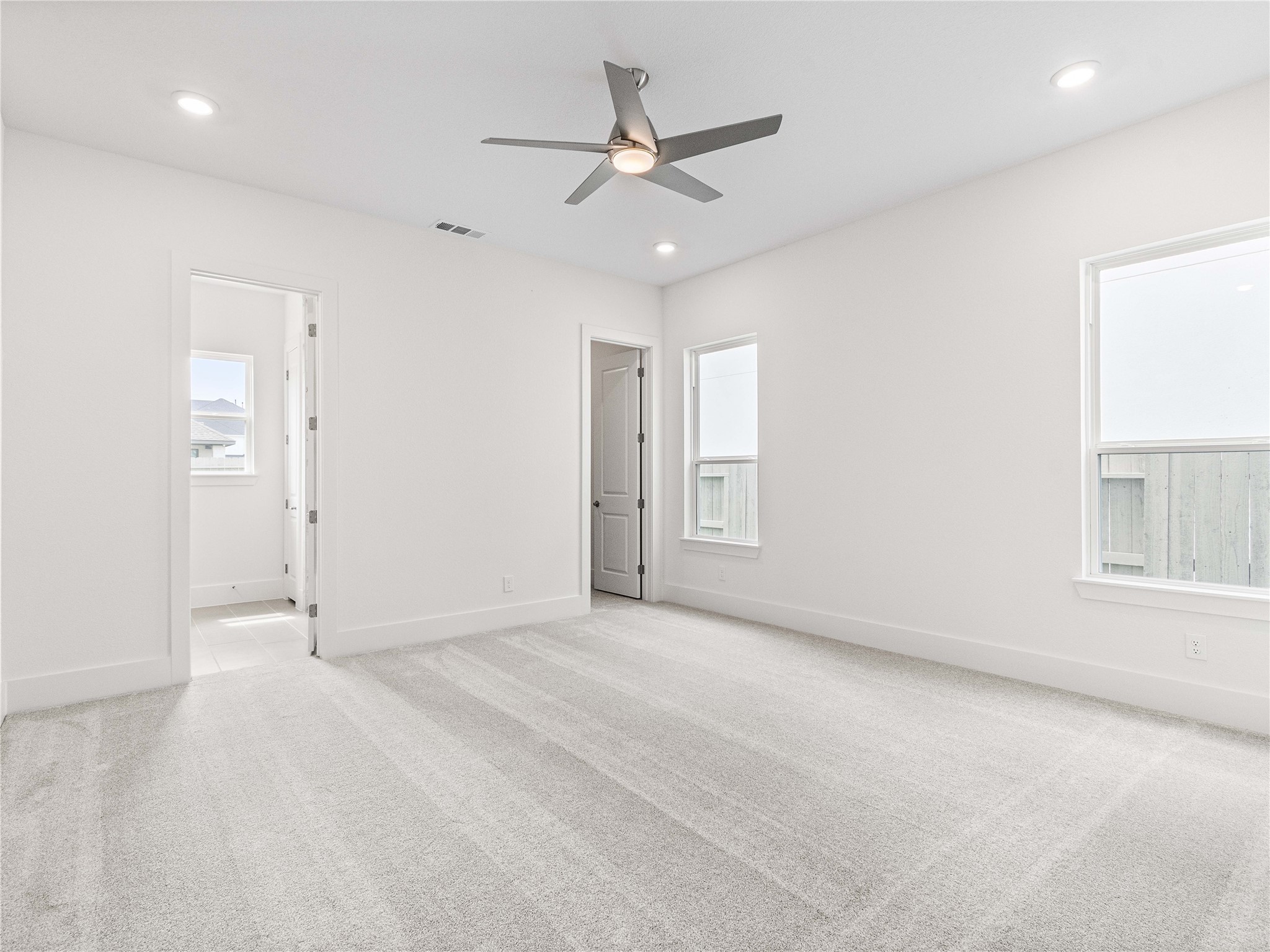 4926 Grapevine Lane Manvel, TX 77578 - Photo 21 of 41 an empty room with fan and windows