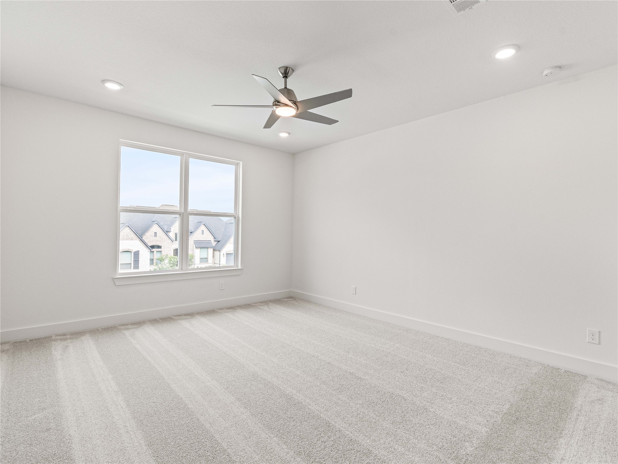 4926 Grapevine Lane Manvel, TX 77578 - Photo 22 of 41 an empty room with windows and fan