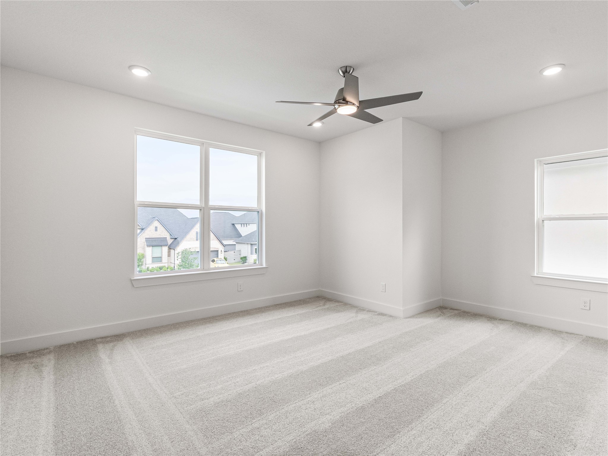 4926 Grapevine Lane Manvel, TX 77578 - Photo 23 of 41 an empty room with windows and fan