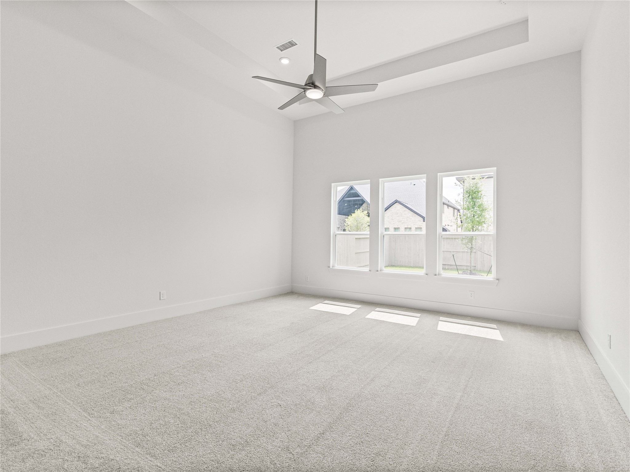4926 Grapevine Lane Manvel, TX 77578 - Photo 27 of 41 an empty room with windows and fan