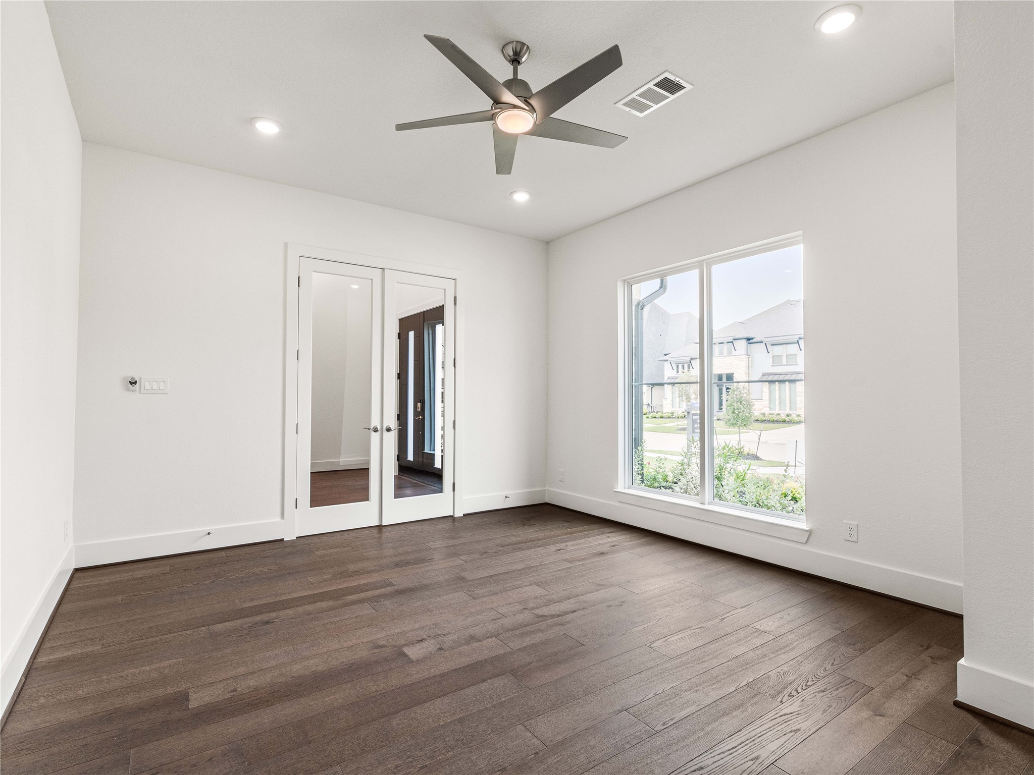 4926 Grapevine Lane Manvel, TX 77578 - Photo 31 of 41 an empty room with wooden floor and windows