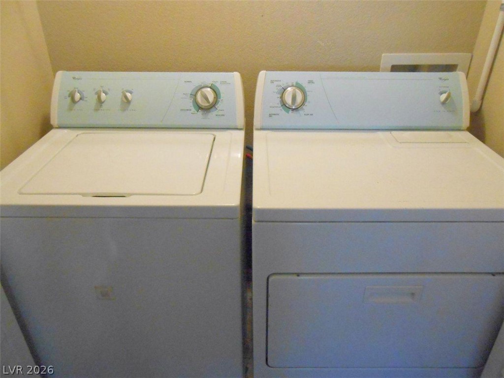 9325 West Desert Inn Road, Unit 132 Las Vegas, NV 89117 - Photo 5 of 36 Functional laundry setup features a washer and dryer, ready for immediate use.