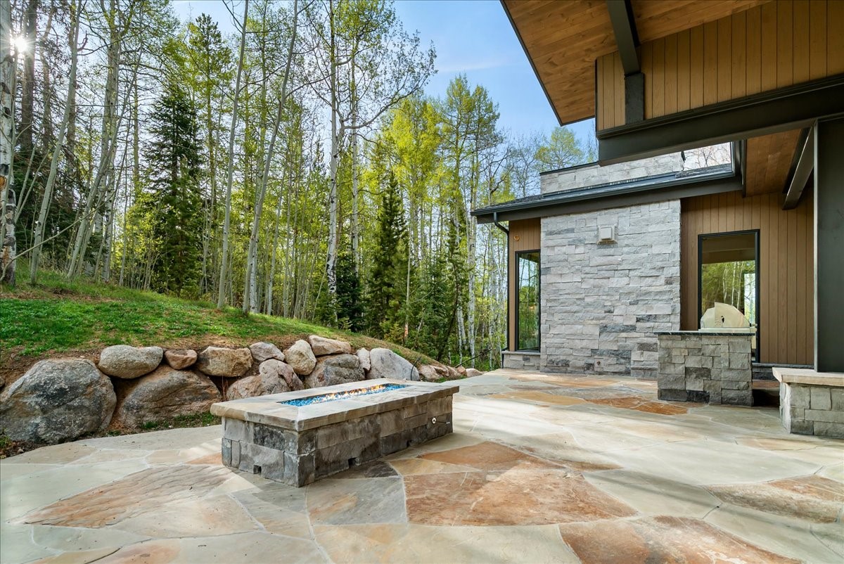 1615 Golden Eagle Road Silverthorne, CO 80498 - Photo 16 of 47 a backyard of a house with fountain table and chairs