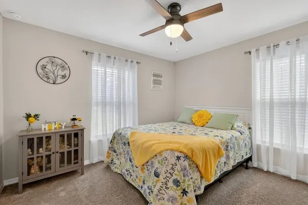 a bed sitting in a bedroom next to a window