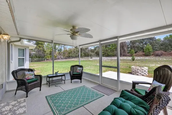 a living room with furniture and a floor to ceiling window