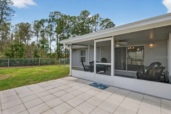 a view of a house with a backyard and a patio