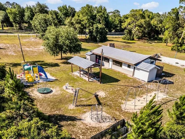 a view of backyard with trampoline