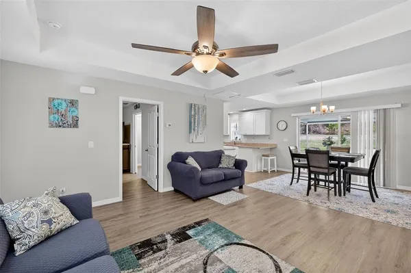 a living room with furniture and a dining table