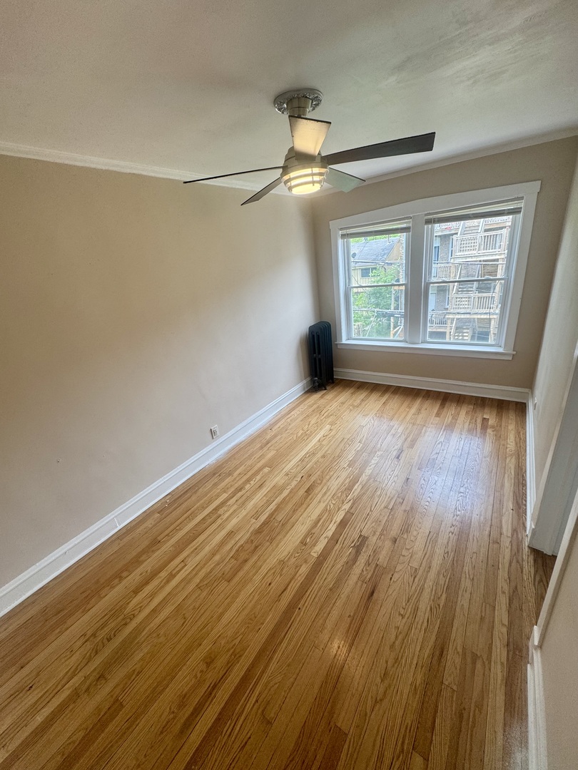 6638 South Greenwood Avenue, Unit 2B Chicago, IL 60637 - Photo 14 of 23 wooden floor in an empty room with a window