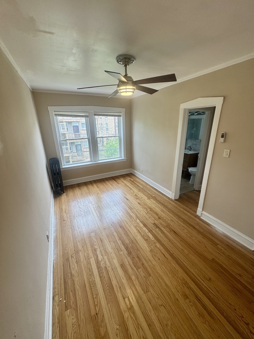 6638 South Greenwood Avenue, Unit 2B Chicago, IL 60637 - Photo 15 of 23 wooden floor in an empty room with a window