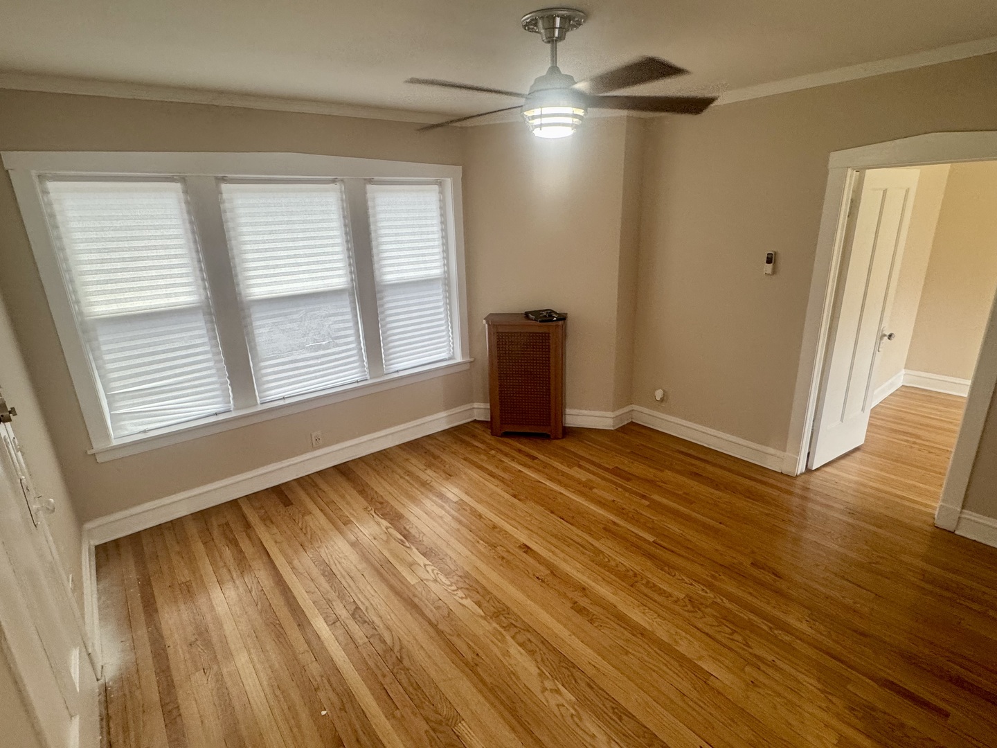 6638 South Greenwood Avenue, Unit 2B Chicago, IL 60637 - Photo 2 of 23 a view of an empty room with wooden floor and a window