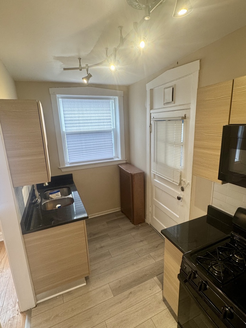 6638 South Greenwood Avenue, Unit 2B Chicago, IL 60637 - Photo 21 of 23 a kitchen with a stove and a refrigerator