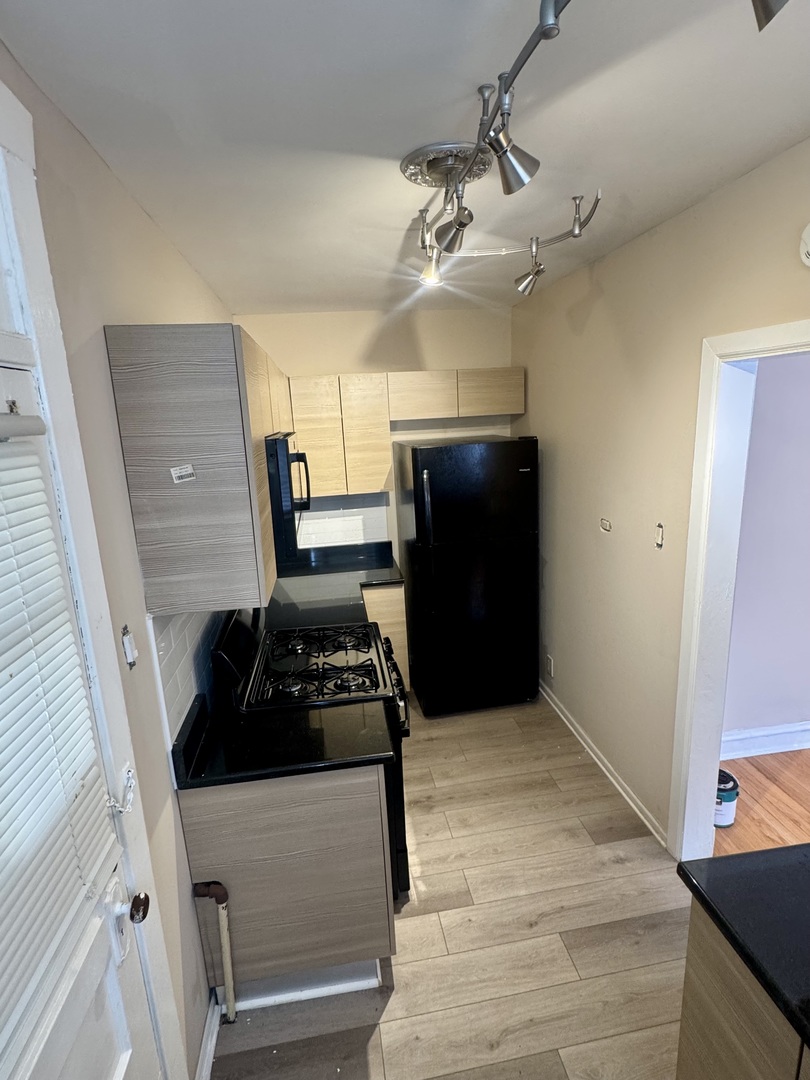6638 South Greenwood Avenue, Unit 2B Chicago, IL 60637 - Photo 22 of 23 a kitchen with a refrigerator and a stove top oven