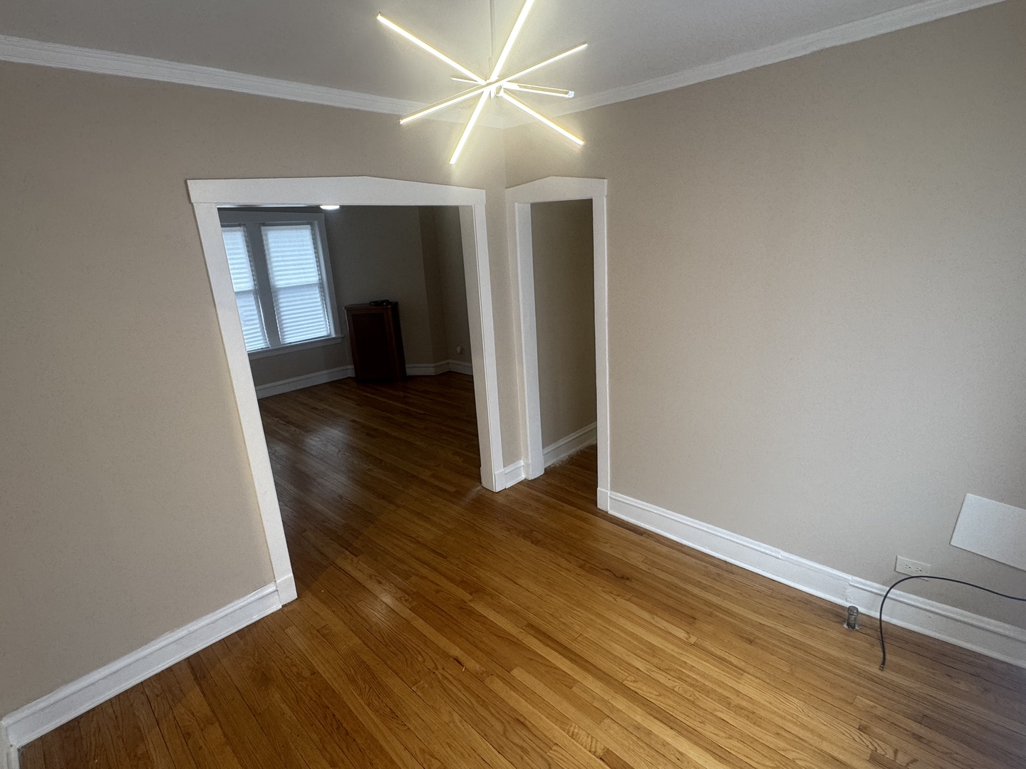 6638 South Greenwood Avenue, Unit 2B Chicago, IL 60637 - Photo 10 of 23 a view of a livingroom with wooden floor and a ceiling fan