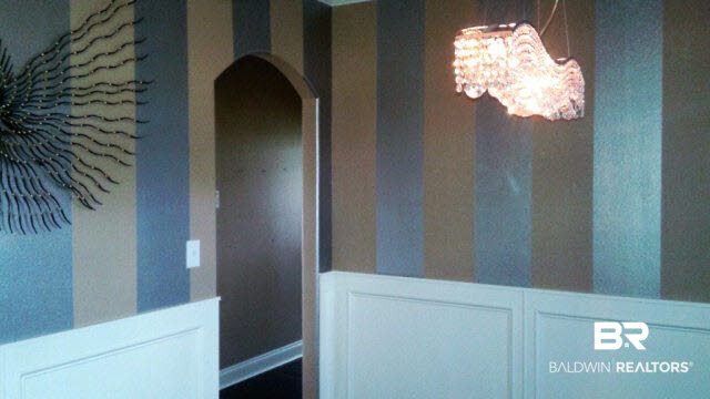 7020 Rocky Rd Loop Gulf Shores, AL 36542 - Photo 10 of 29 Dining room has wainscoating, designer wallpaper, and upgraded lighting