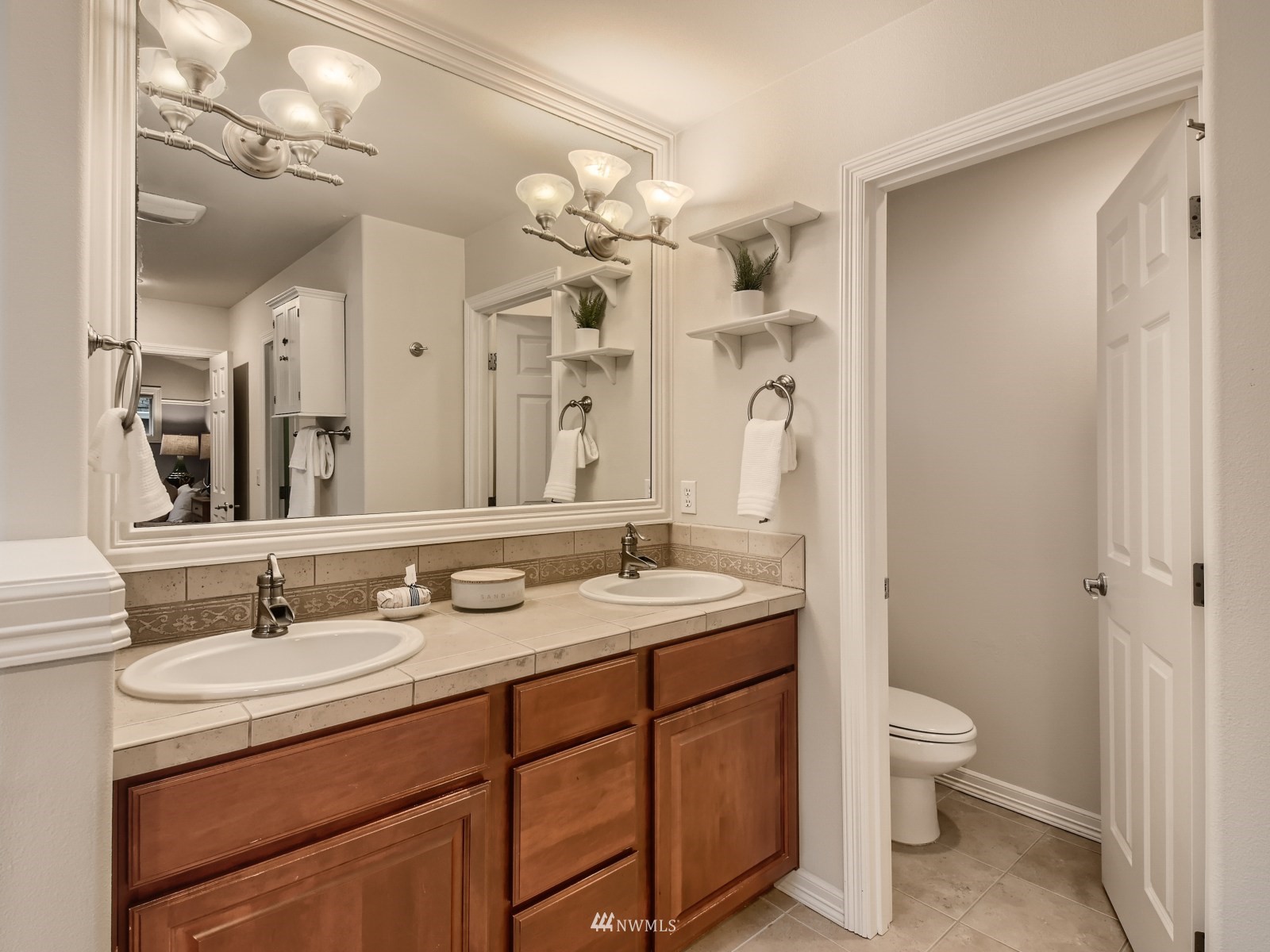 5232 Northeast 3rd Place Renton, WA 98059 - Photo 15 of 28 a bathroom with a granite countertop sink a toilet and a mirror
