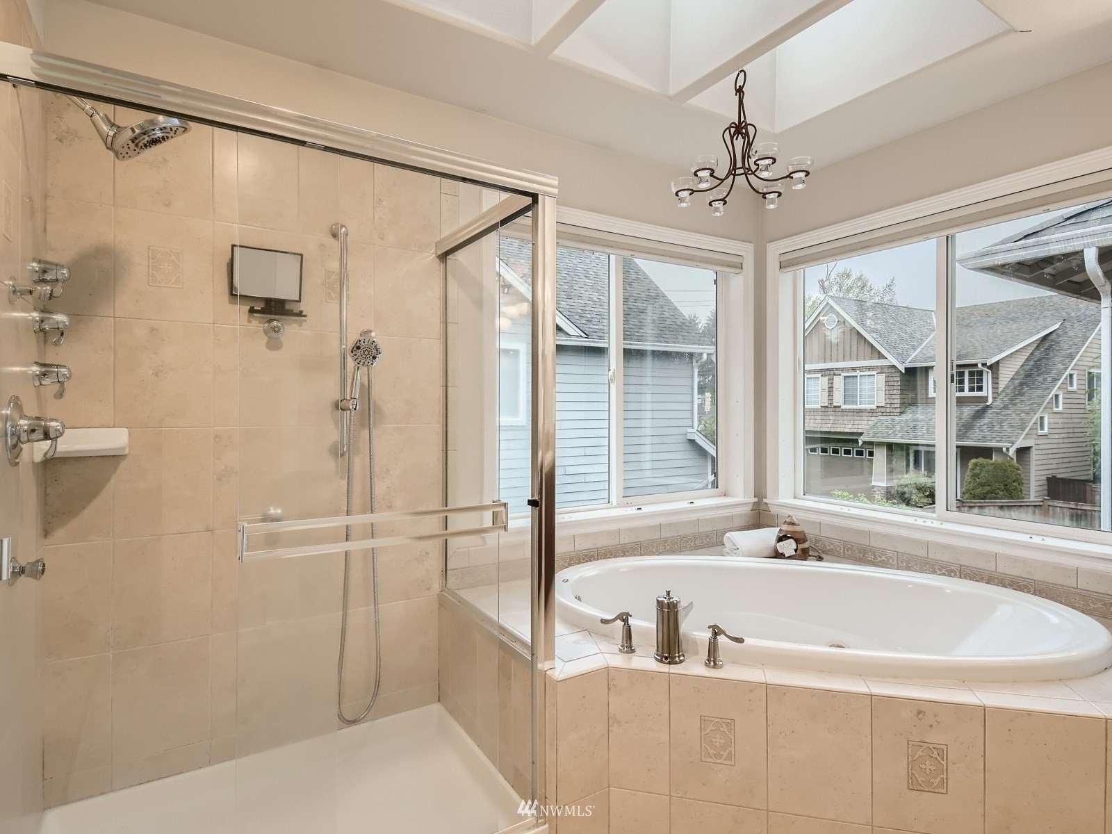 5232 Northeast 3rd Place Renton, WA 98059 - Photo 16 of 28 a spacious bathroom with a tub a chandelier and windows