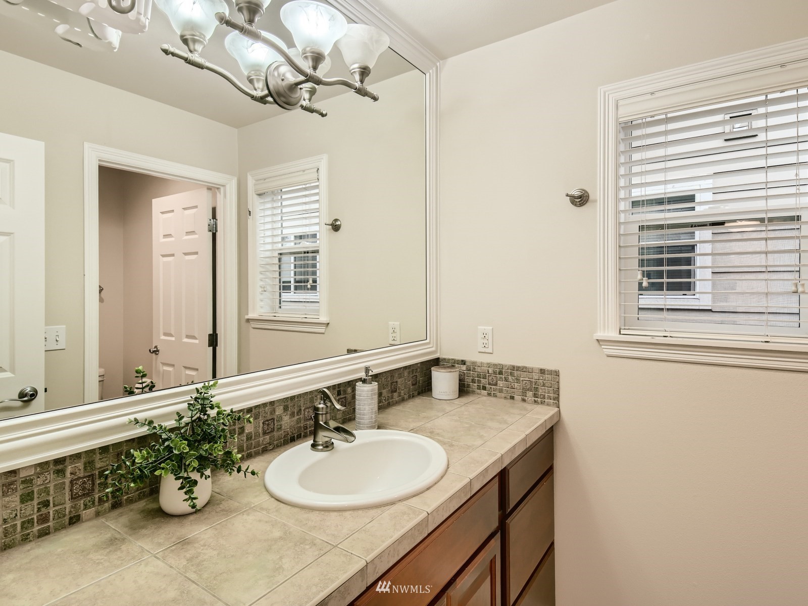 5232 Northeast 3rd Place Renton, WA 98059 - Photo 21 of 28 a bathroom with a sink a vanity and a mirror