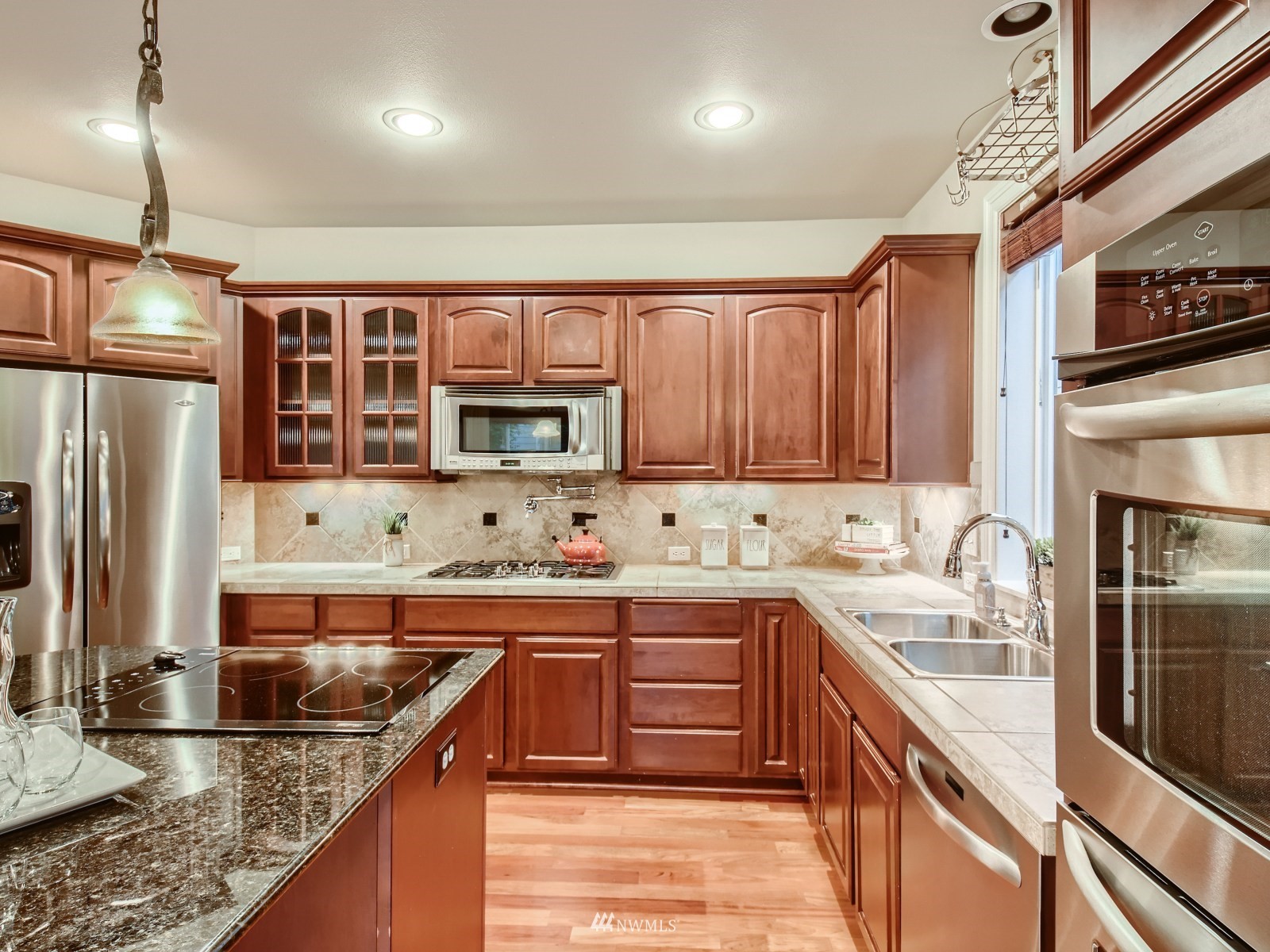 5232 Northeast 3rd Place Renton, WA 98059 - Photo 8 of 28 a kitchen with stainless steel appliances granite countertop a sink a stove and a refrigerator