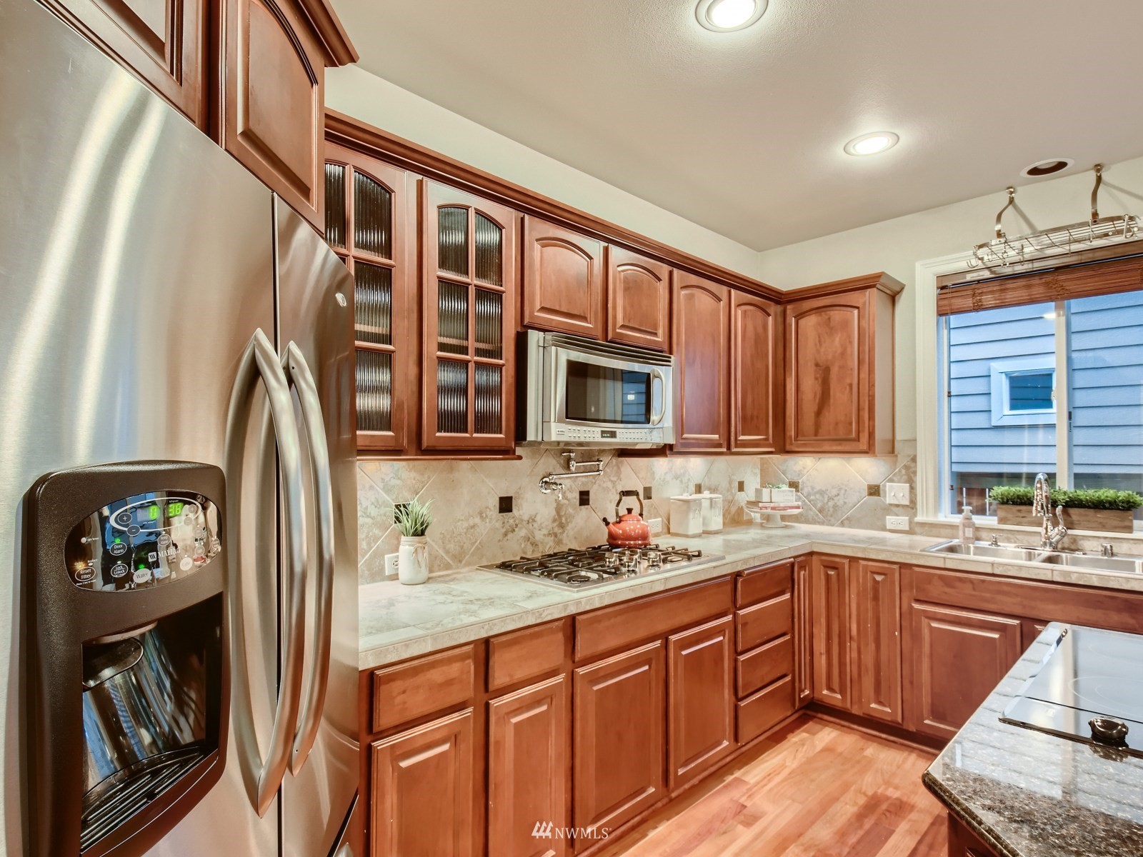 5232 Northeast 3rd Place Renton, WA 98059 - Photo 9 of 28 a kitchen with stainless steel appliances granite countertop a sink stove and cabinets