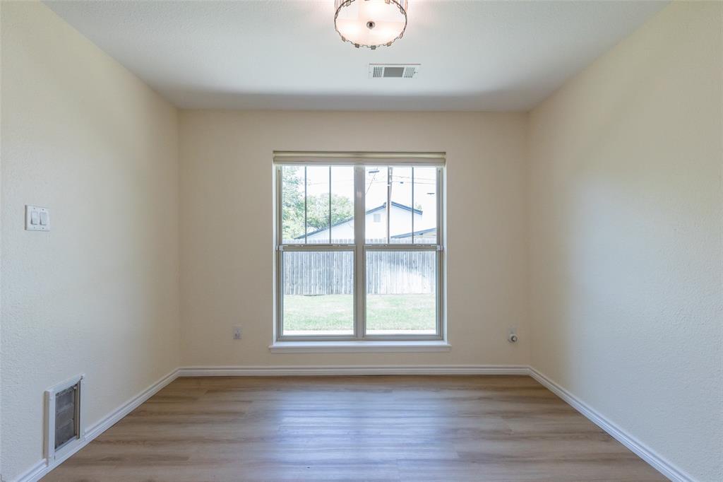40 Carriage Road Abilene, TX 79605 - Photo 12 of 40 an empty room with wooden floor and windows