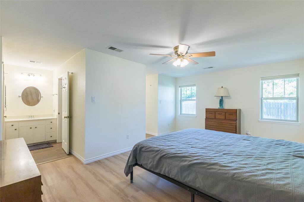 40 Carriage Road Abilene, TX 79605 - Photo 18 of 40 a bedroom with a large bed and a chandelier