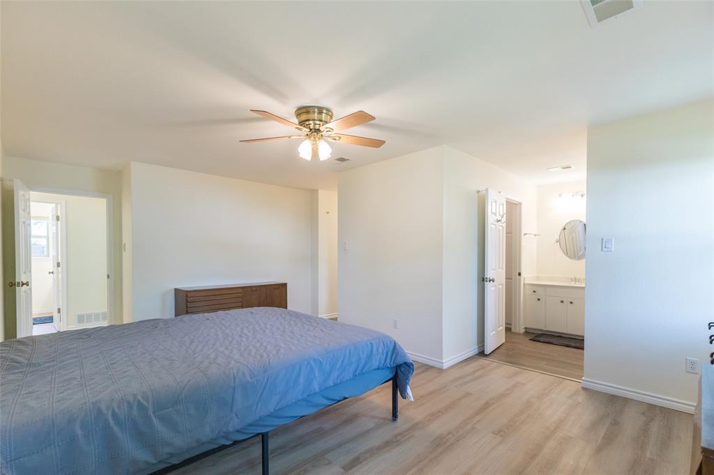 40 Carriage Road Abilene, TX 79605 - Photo 19 of 40 a bedroom with a bed and a chandelier