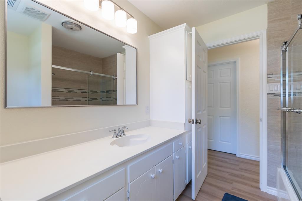 40 Carriage Road Abilene, TX 79605 - Photo 29 of 40 a bathroom with a sink a mirror and a shower