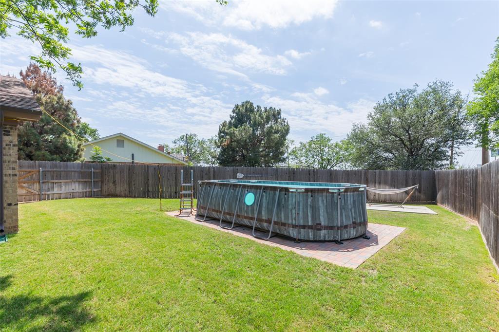 40 Carriage Road Abilene, TX 79605 - Photo 37 of 40 a view of a backyard with a small cabin and a chair