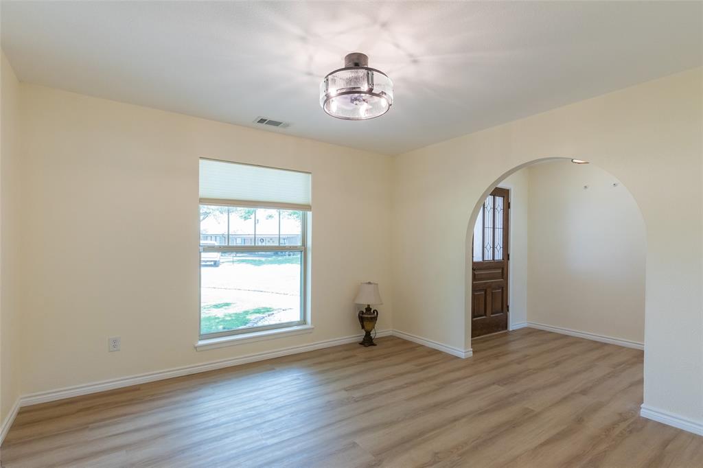 40 Carriage Road Abilene, TX 79605 - Photo 6 of 40 an empty room with wooden floor and windows