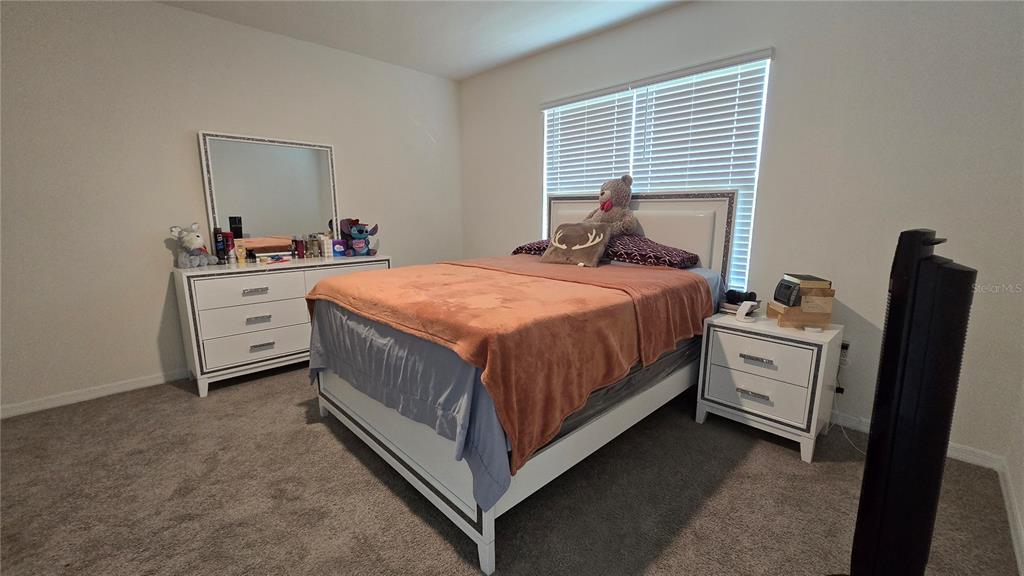 1784 Bull Hl Road Kissimmee, FL 34744 - Photo 11 of 33 a spacious bedroom with a bed and a dresser