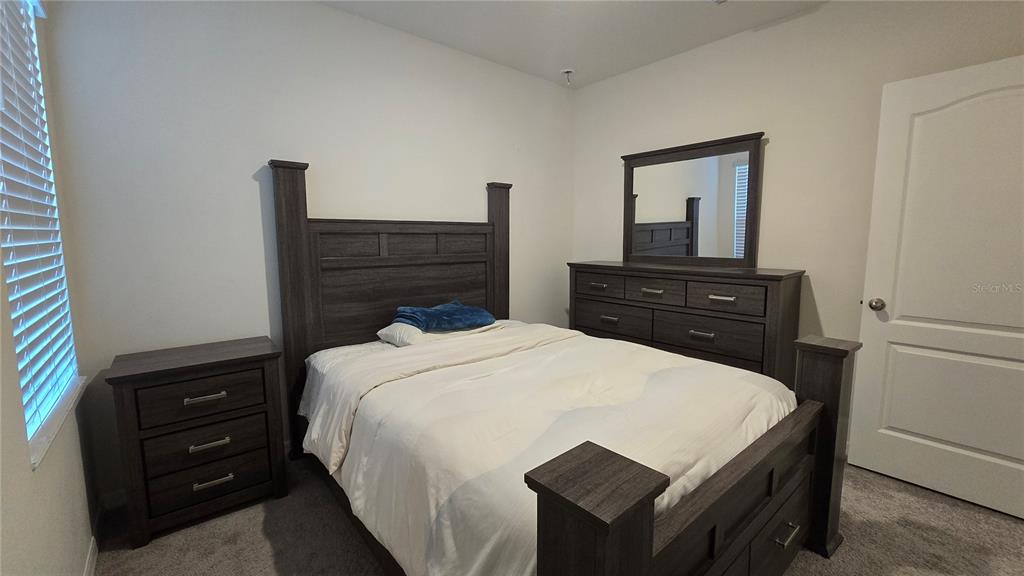 1784 Bull Hl Road Kissimmee, FL 34744 - Photo 13 of 33 a bedroom with a bed and a dresser