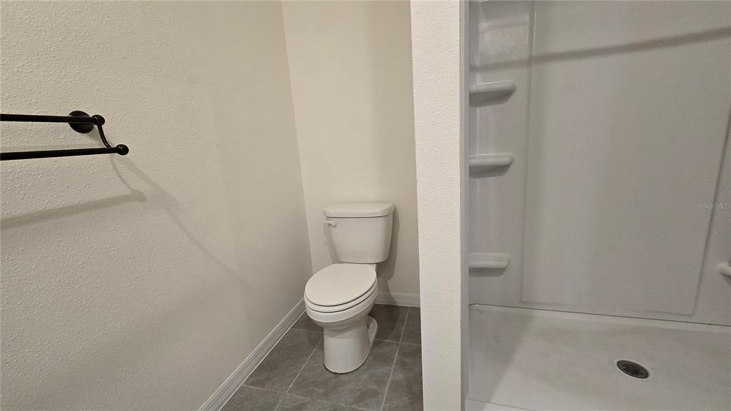 1784 Bull Hl Road Kissimmee, FL 34744 - Photo 18 of 33 a bathroom with a toilet and a shower