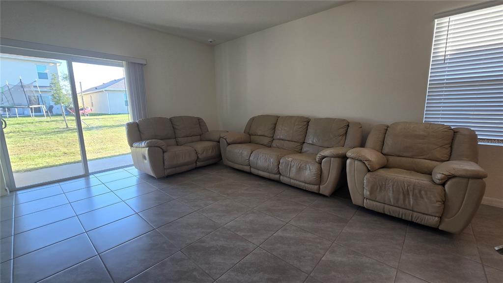 1784 Bull Hl Road Kissimmee, FL 34744 - Photo 20 of 33 a living room with couches and a coffee table