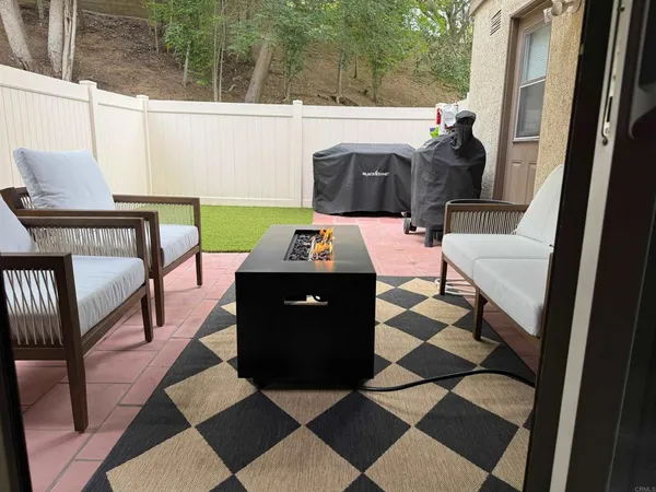 a backyard of a house with table and chairs