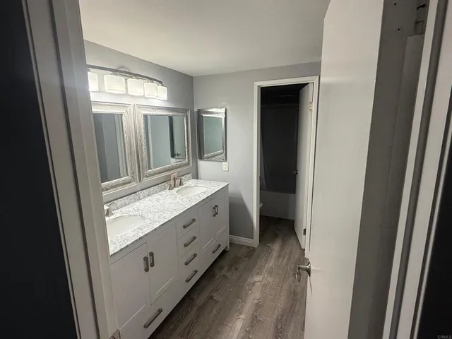 a bathroom with a double vanity sink and mirror