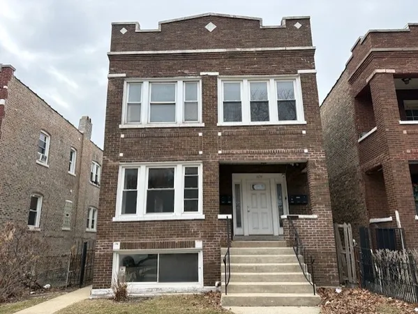 a front view of a brick building with many windows
