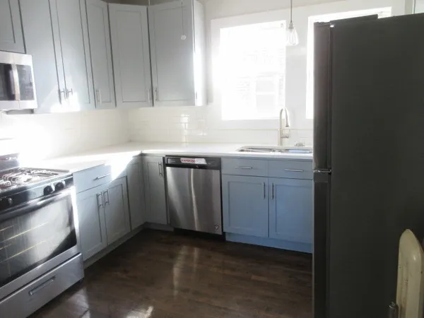 a kitchen with a sink stove and cabinets