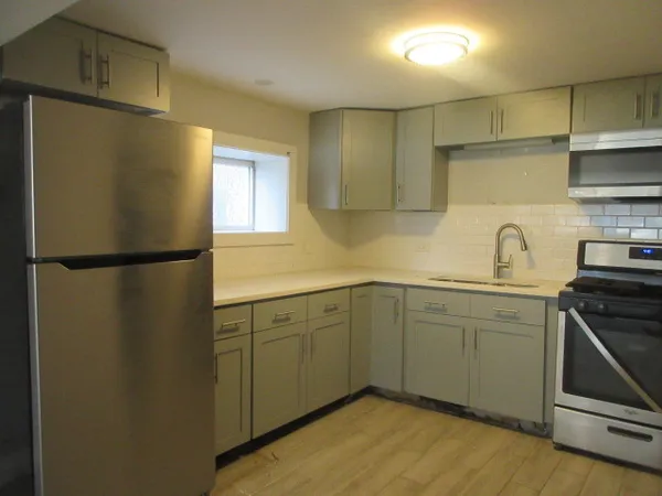 a kitchen with stainless steel appliances granite countertop a refrigerator sink and cabinets