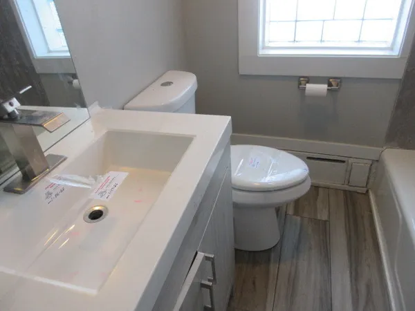 a bathroom with a sink toilet and tub