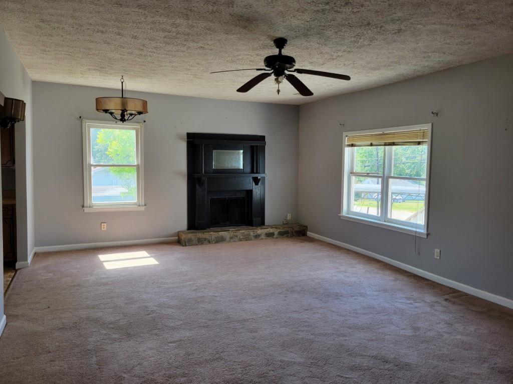 7217 Union Grove Road Lithonia, GA 30058 - Photo 2 of 12 a view of empty room with windows and ceiling fan