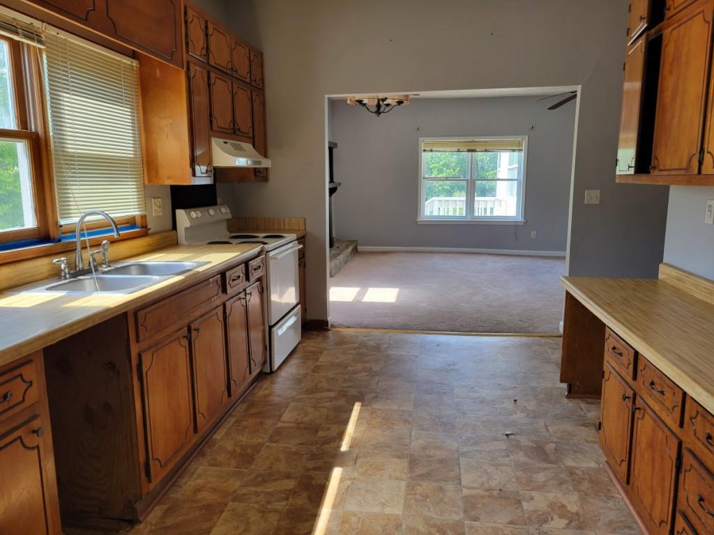 7217 Union Grove Road Lithonia, GA 30058 - Photo 3 of 12 a kitchen with a sink stove and cabinets