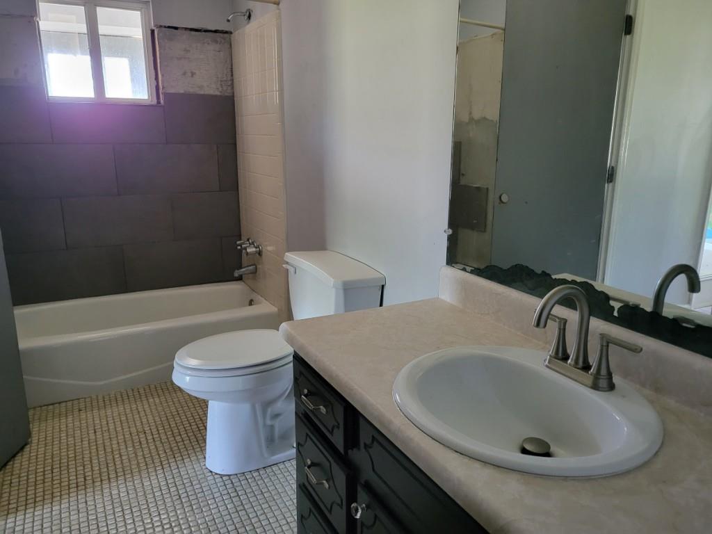 7217 Union Grove Road Lithonia, GA 30058 - Photo 5 of 12 a bathroom with a sink and a mirror