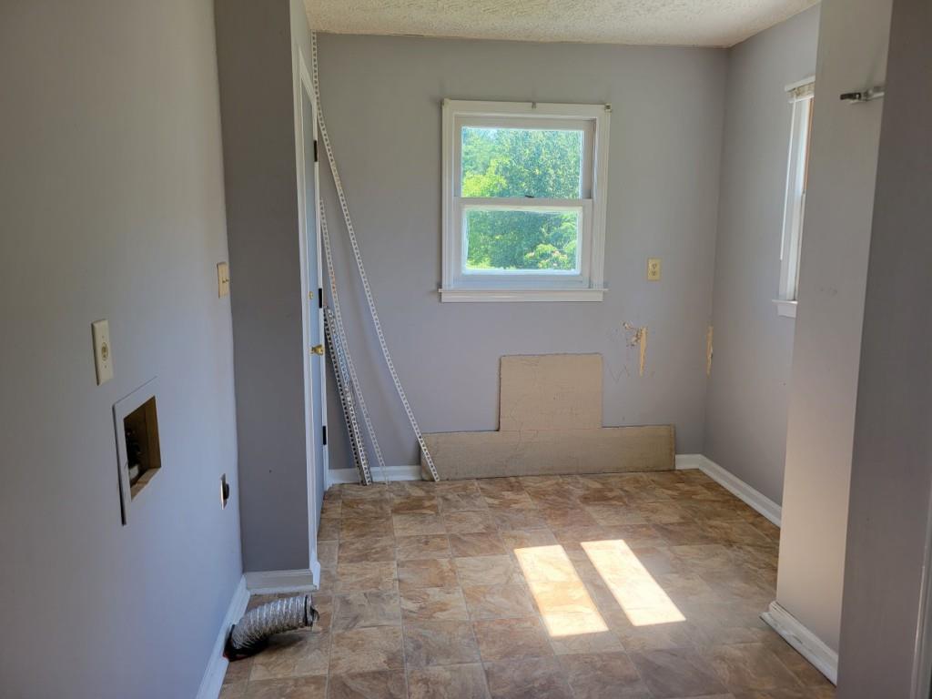 7217 Union Grove Road Lithonia, GA 30058 - Photo 9 of 12 an empty room with windows
