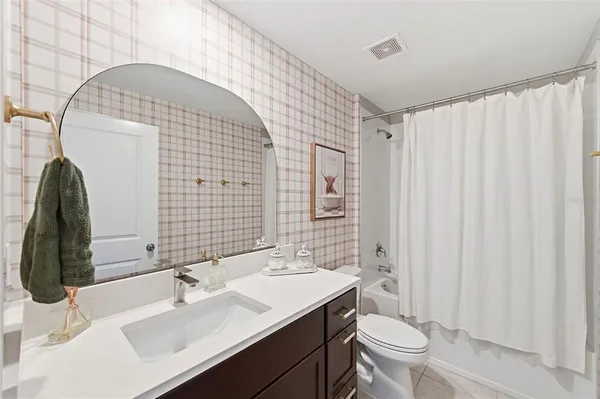 a bedroom with a bed and a ceiling fan