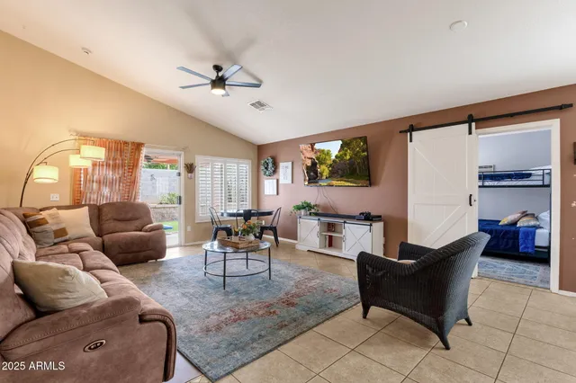 a living room with furniture and kitchen view