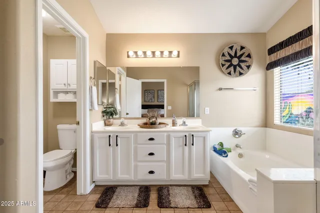 a bathroom with a tub a sink and a window