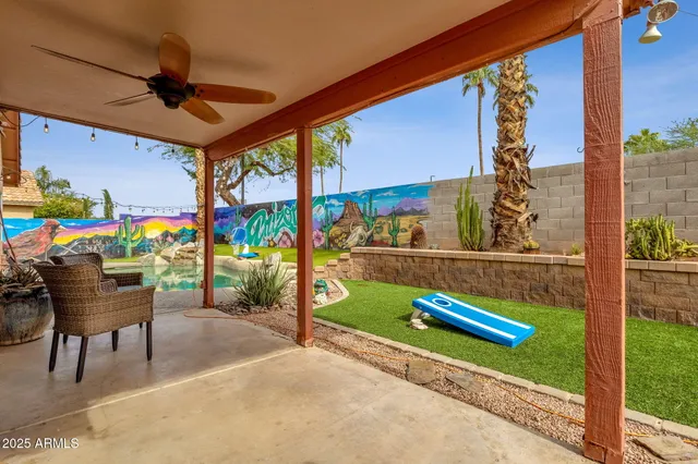 a view of a porch with furniture and a yard