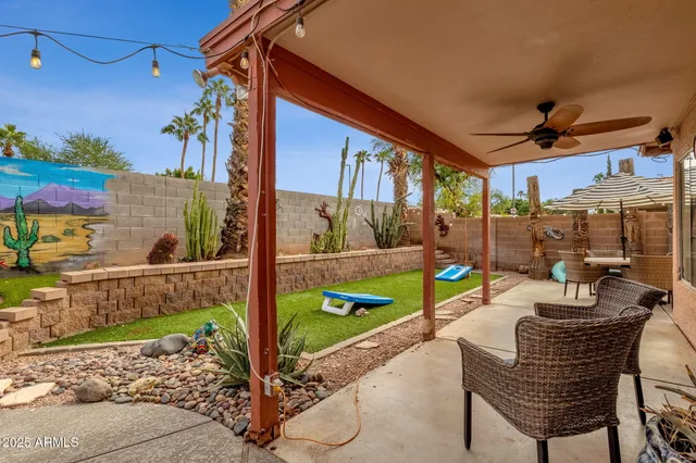 a swimming pool with outdoor seating and yard